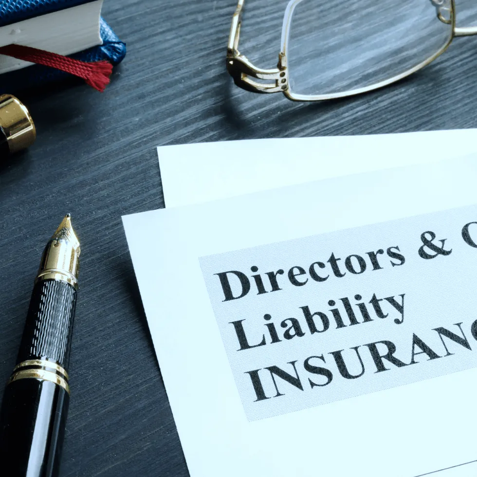 insurance-agent-placing-hands-protectively-over-paper-model-of-businessman